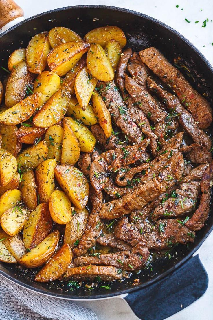 Garlic butter steak bites with golden herb potato wedges