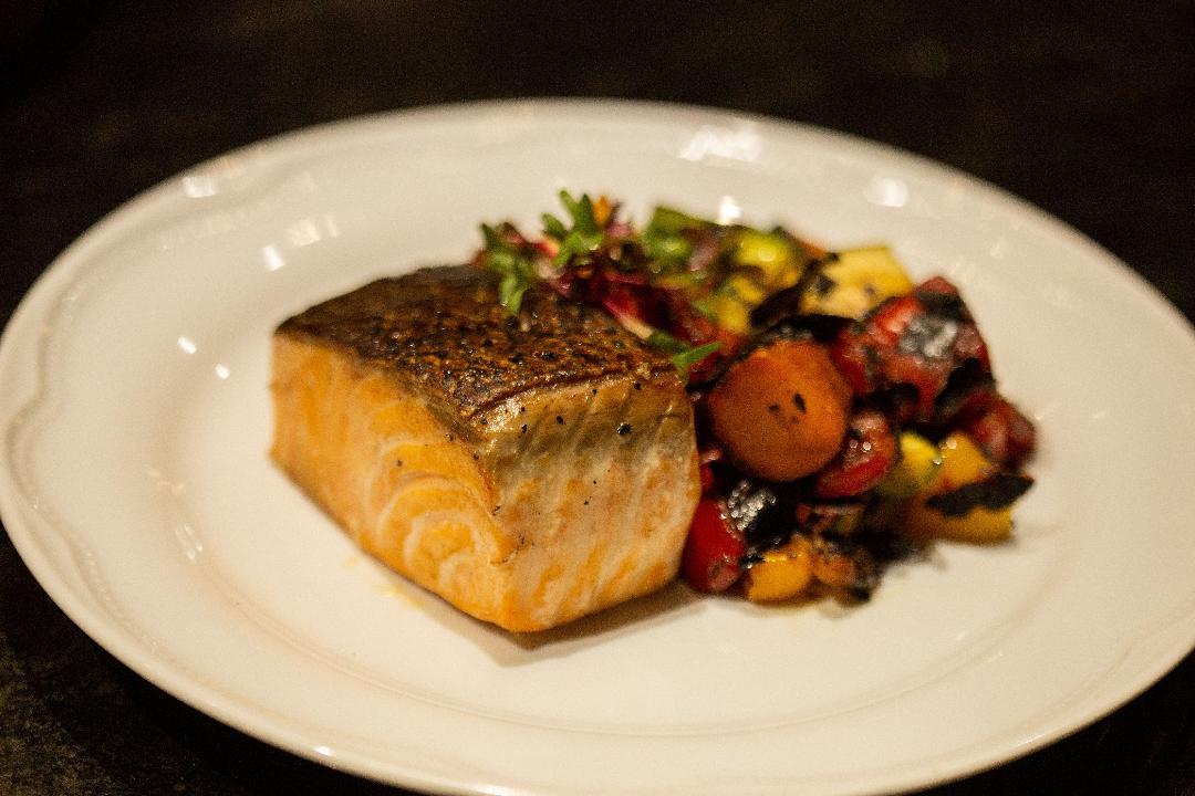 Pan-seared salmon fillet with roasted vegetables